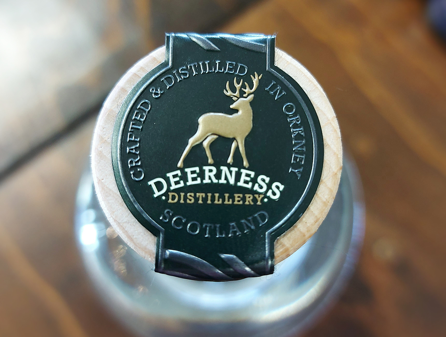 Close up of Deerness Distillery metal bottle top strap